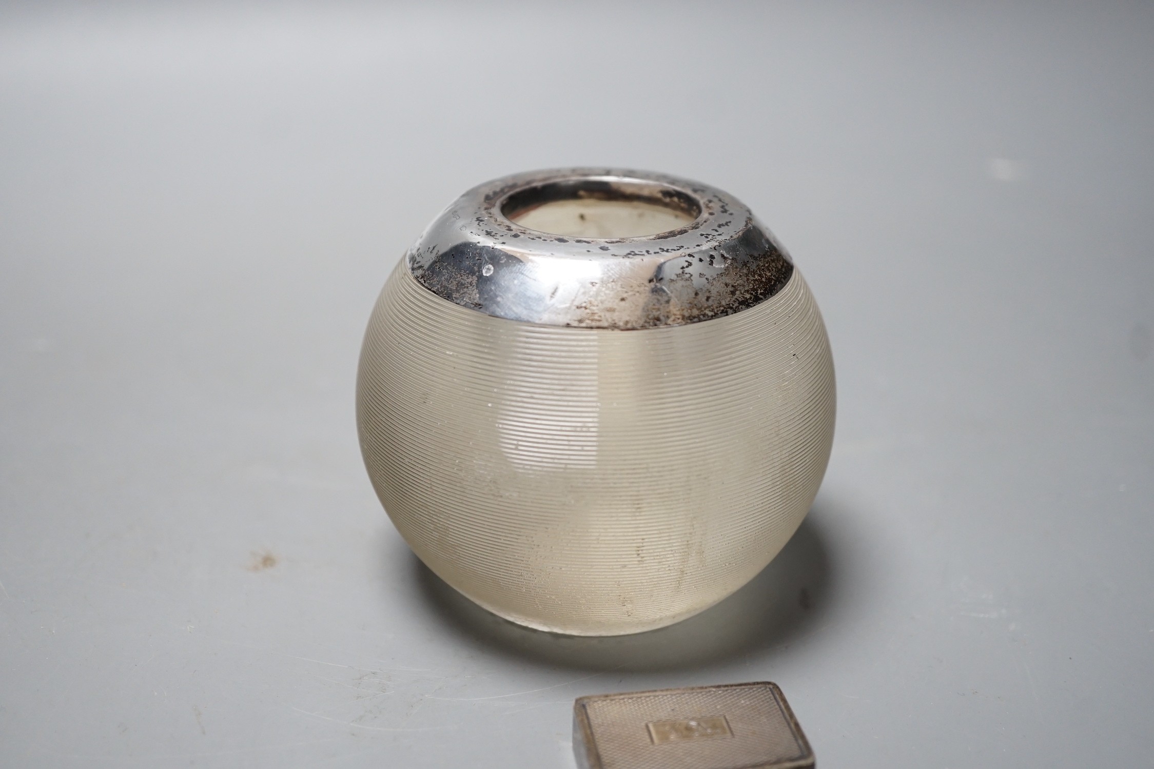 A George V silver mounted ribbed glass match strike, height 75mm and a late Victorian silver pill box.